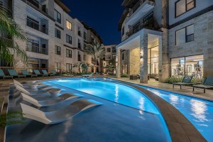 Apartments for rent in Houston's Energy Corridor - Pool with Tanning Shelf and Patio Lit Up at Night             