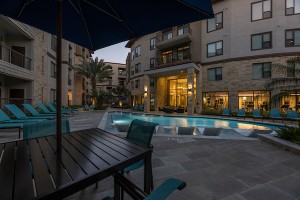 Apartments for rent in Houston's Energy Corridor - Outdoor Patio and Pool with Tanning Shelf Lit Up at Night
